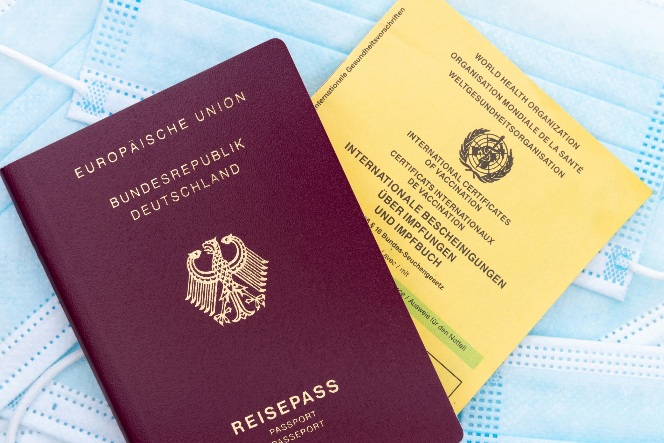 Passport and international health documents prepared for travel insurance planning